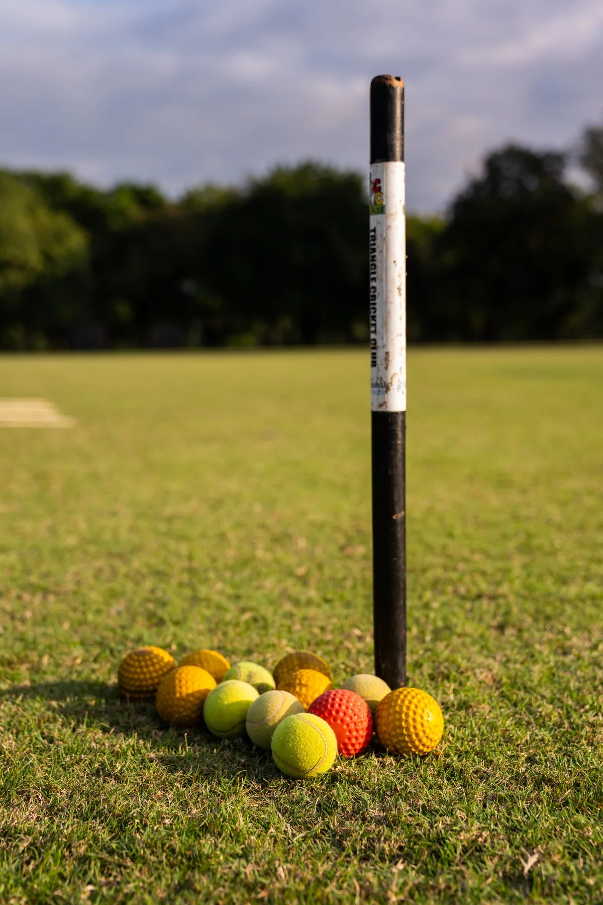 A Triangle Cricket Club stump and practice balls on the outfield